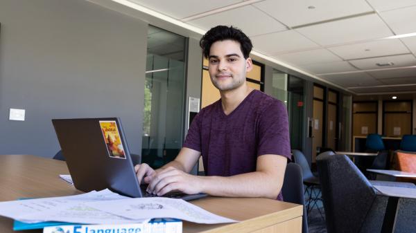 A SILC student doing homework on a laptop